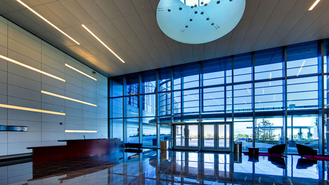 Interior lobby of the University Center facing east towards the main entrance with lots of windows and a skylight.