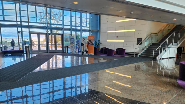 Interior lobby of the University Center facing east towards the main entrance and the stairs to the second level on the right.