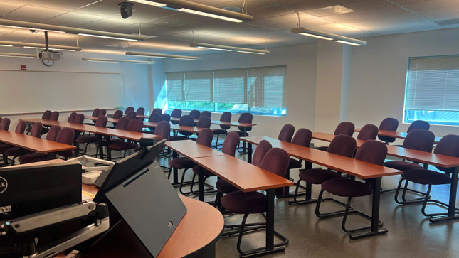 Room 207 on the second floor at the University Center with chairs/table layout.