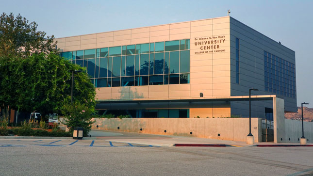 View of the University Center from the parking lot. The image shows accessibility features such as curb cuts.